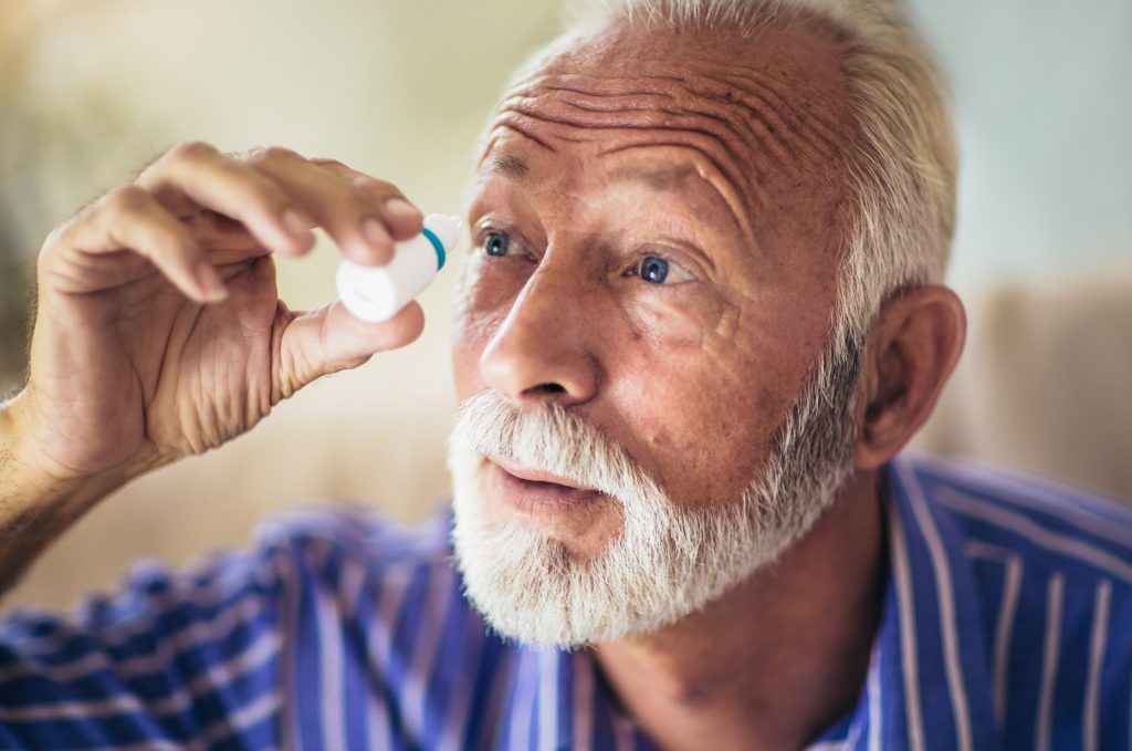 A close up of a person with blue eyes looking at the camera
